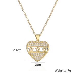 Detailed view of gold heart pendant with zircon inlay and star patterns showing dimensions