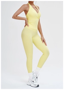 Side view of vibrant yellow brushed yoga set with halter v-neck top and high waist leggings