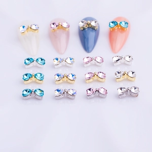 Colorful bow nail art charms featuring heart-shaped rhinestones on alloy bases