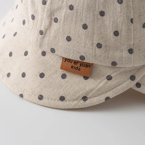 Infant cotton linen sun hat with geometric polka dot print and wide brim for summer travel