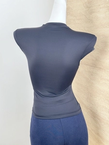 Rear view of tight black high-stretch sports t-shirt showing the waist-cinching fit on mannequin