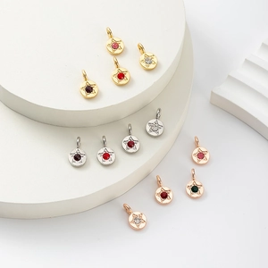 Macro shot of colorful round birthstone pendants in gold, silver, and rose gold finishes