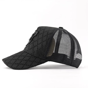 Detail of black baseball cap showing checkered texture fabric and breathable mesh back