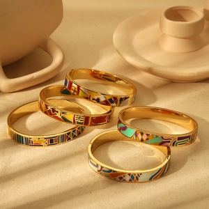 Set of stackable 18k gold plated enamel bangles with vibrant geometric patterns