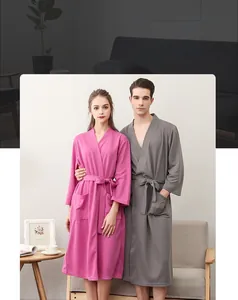 Detail of pink and grey waffle weave bathrobes showing soft texture and V-neck design