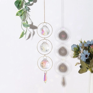 Detailed view of AB crystal suncatcher with golden rings casting rainbow reflections