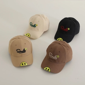 Detailed flat lay of cotton baseball caps with Smile embroidery and yellow patch design