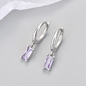 Macro detail of S925 silver earring featuring a polished rectangular purple zircon stone