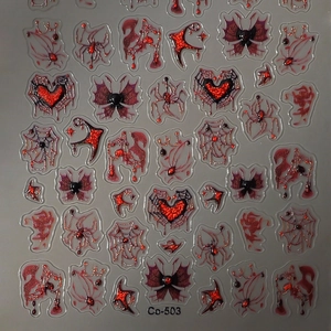 Gothic nail art decals featuring red glitter spider webs, black butterflies and moon symbols