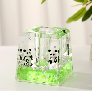 Macro shot of liquid filled acrylic panda pen holder with floating laser flowers