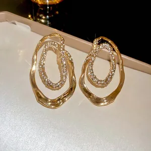 Irregular gold oval double hoop earrings with sparkling pavé crystals for women