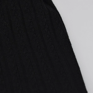 Close-up of the black ribbed knit fabric texture showing elastic vertical stripes