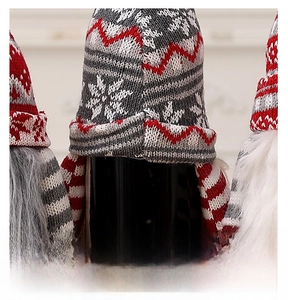 Detailed back view of knitted Christmas gnome wine bottle cover with snowflake patterns
