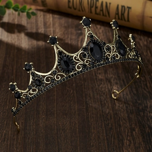 Macro detail of vintage bronze crown with black gemstones on a wooden background