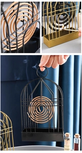 Detail of birdcage iron mosquito coil holder with ash tray in black and gold metal