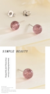 Detailed close-up of pink round strawberry quartz studs with shimmering inclusions