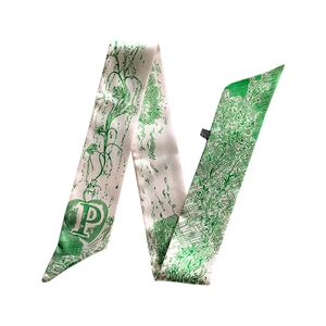 Detail of silk scarf showing vintage green botanical pattern and letter P design