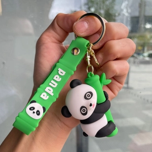 Detailed close-up of a 3D panda holding bamboo with a green silicone strap and metal ring