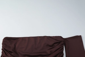 Detailed view of the dark brown ruched fabric and texture on this French style dress set