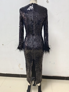 Detail of sequin evening gown featuring elegant ostrich feather trim on the sleeves