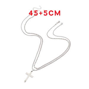 Detail of silver layered cross necklace showing twist chain and M letter pendant