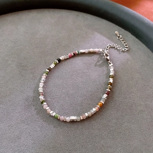 Detail of colorful gemstone beads with silver square spacers and adjustable chain