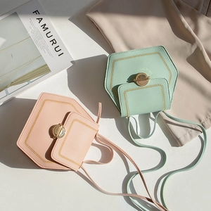 Mint green and pink hexagonal crossbody bags with chain stitching and metal turn-lock