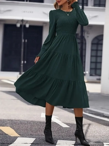 Elegant dark green tiered midi dress with smocked bodice and long ruffled sleeves