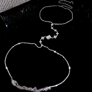 Detail of silver rhinestone body chain featuring geometric square diamond accents for women