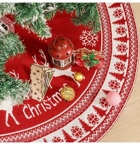 Detailed knitted Christmas tree skirt with reindeer patterns on rustic wood floor
