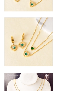 Detail of heart-shaped green gemstone necklace and earrings set on a jewelry bust