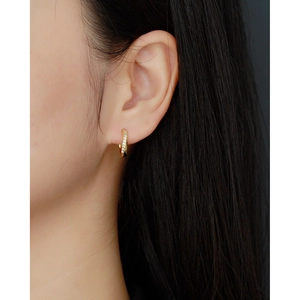 Irregular S925 silver gold-plated hoop earring with sparkling zircon on model ear