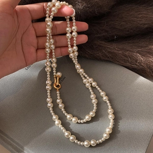 Double-layered pearl necklace with golden U-shaped clasp in a vintage French style