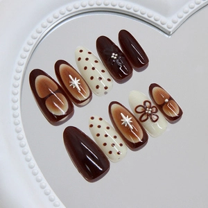 Retro chocolate and cream press-on nails with floral accents and star charms