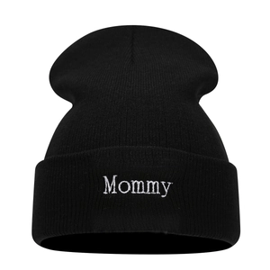 Black knit beanie with Mommy white embroidery features a cuffed design for winter