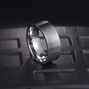 Modern 8mm silver titanium steel ring with grooved texture for men on black display