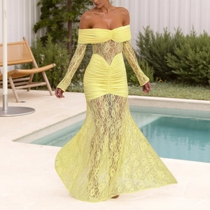 Detailed texture of yellow off-shoulder lace maxi dress with long sleeves in outdoor setting
