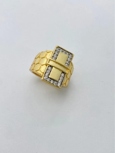 Macro detail of gold plated wide ring featuring buckle design and honeycomb texture band