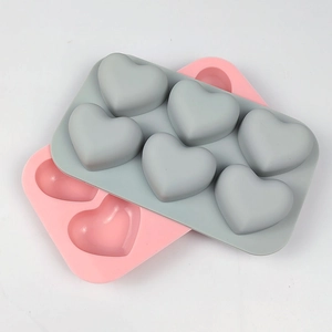 Macro view of grey and pink 6-cavity heart silicone molds for mousse and chocolate baking