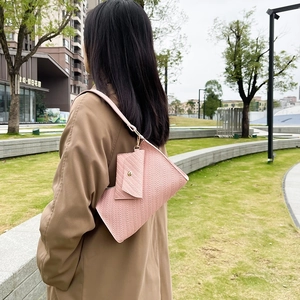 Pale pink textured leather underarm bag set with matching mini pouch and embossed pattern