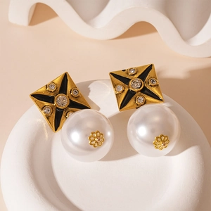 Detailed view of vintage square stud with black enamel, crystals and hanging pearl