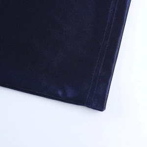 Detail of navy blue evening dress showing premium silk texture and fine double stitching