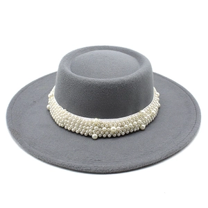 Detailed close-up of dark grey wool felt flat top hat featuring white faux pearl band