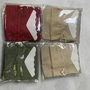 Close-up of burlap Christmas drawstring wine bags with felt wings in various colors