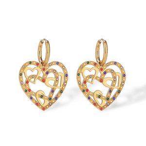 Detailed shot of gold heart earrings with multi-colored crystals and hollow design