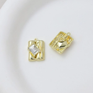 Macro view of gold plated rectangular zircon pendant showing front and back craftsmanship