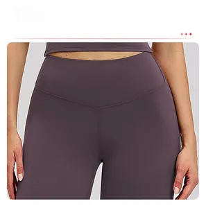 Detail view of high-waisted purple yoga pants featuring Y-shaped stitching and matte fabric