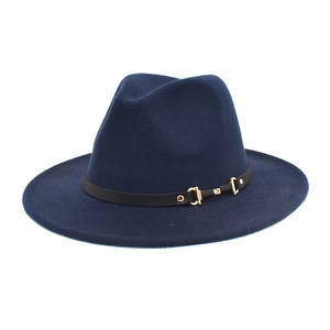 Detail of dark blue felt fedora hat featuring a black leather band and gold buckle