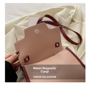 Close-up of metal magnetic buckle and lychee grain leather texture on pink crossbody bag