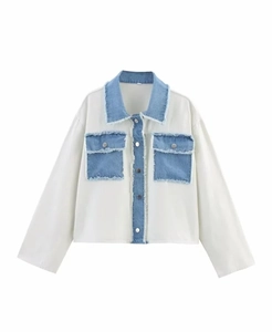 Detail of white knit and blue denim patchwork jacket with collar and chest pockets